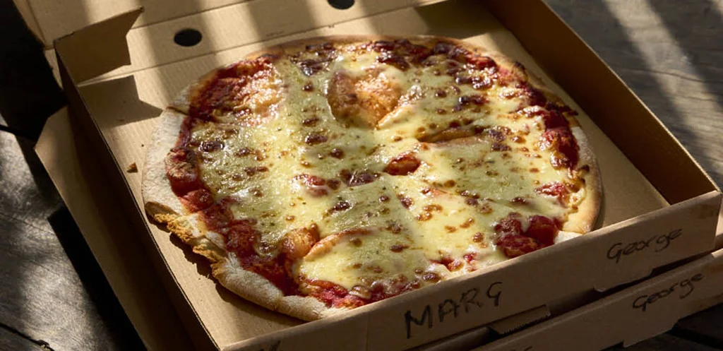 Margherita Pizza in a cardboard takeaway box at The Hub Cafe, Bodiam